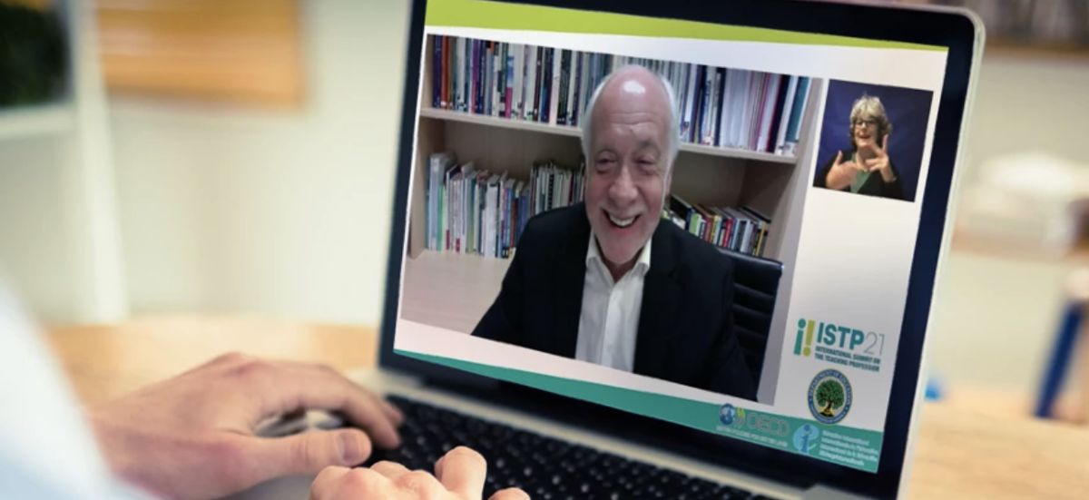 A remote speaker on a laptop with an ASL interpreter picture-in-picture